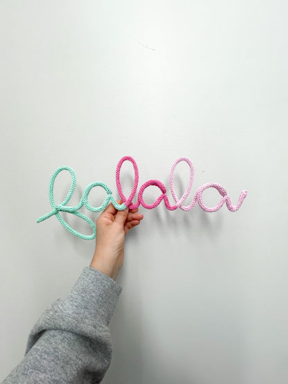Custom colorway for fa la la sign - features mint to pink knitted wire word sign.