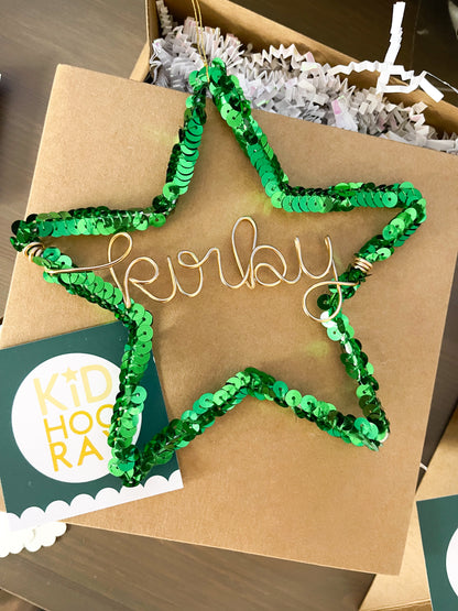 Green sequin star ornament personalized with the name Kirby in gold wire, ready as a handmade Christmas gift or holiday tree decoration.