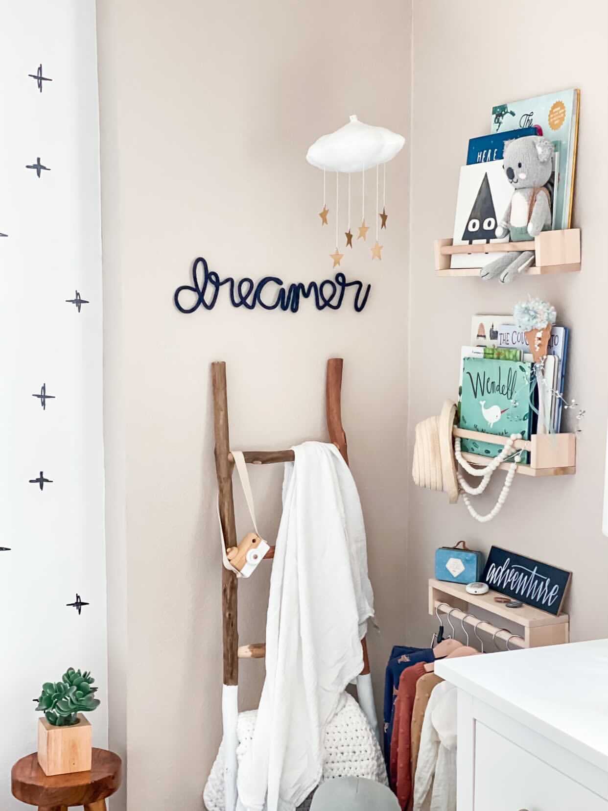 Knitted wire word styled on a child's bedroom reading corner above a set of bookshelves,.