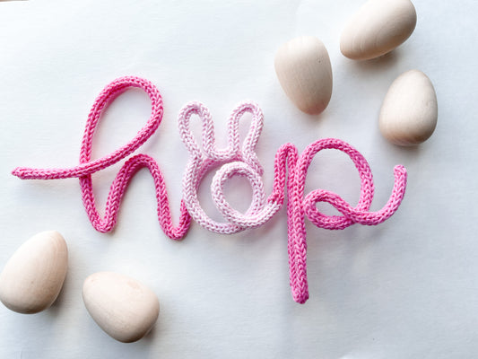Knitted wire word "hop" featuring bunny ears on the "h".