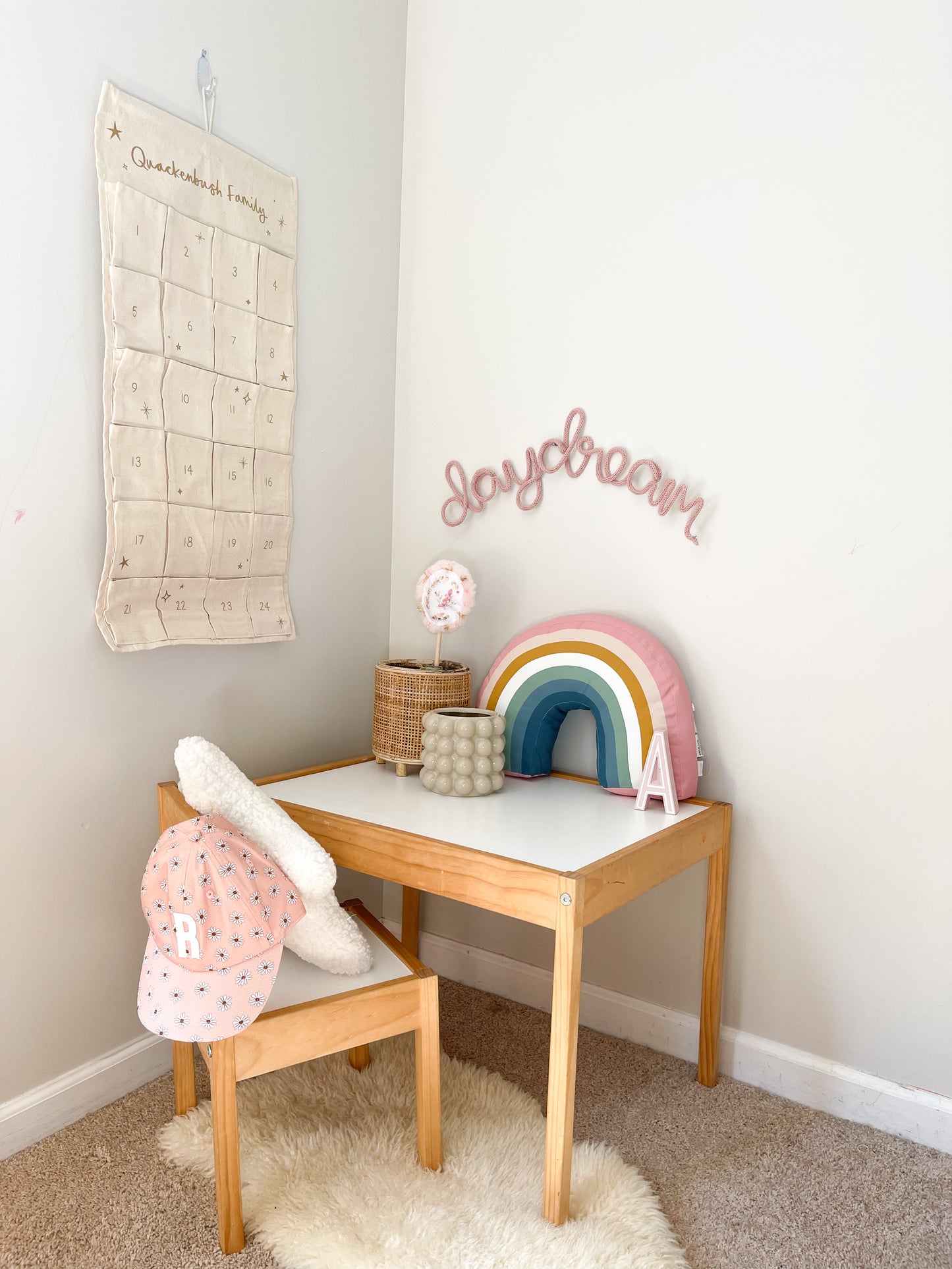 Knitted wire word sign daydream. It's hung above a child's desk in a girl's room.