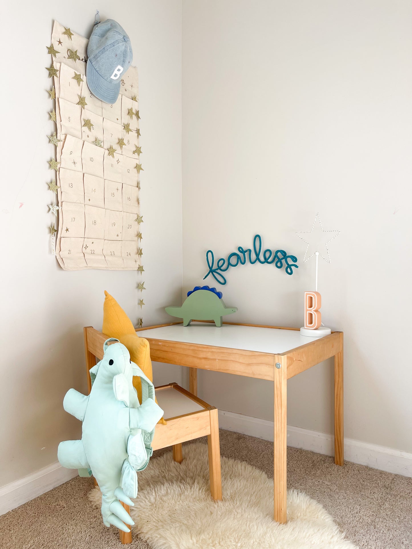 Knitted wire word "fearless". Hung above child's desk. 