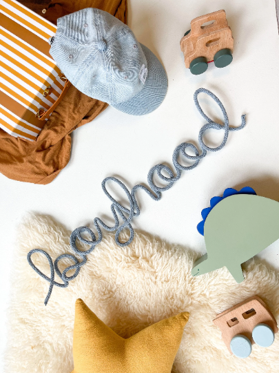 Knitted wire word "boyhood" flatlay.