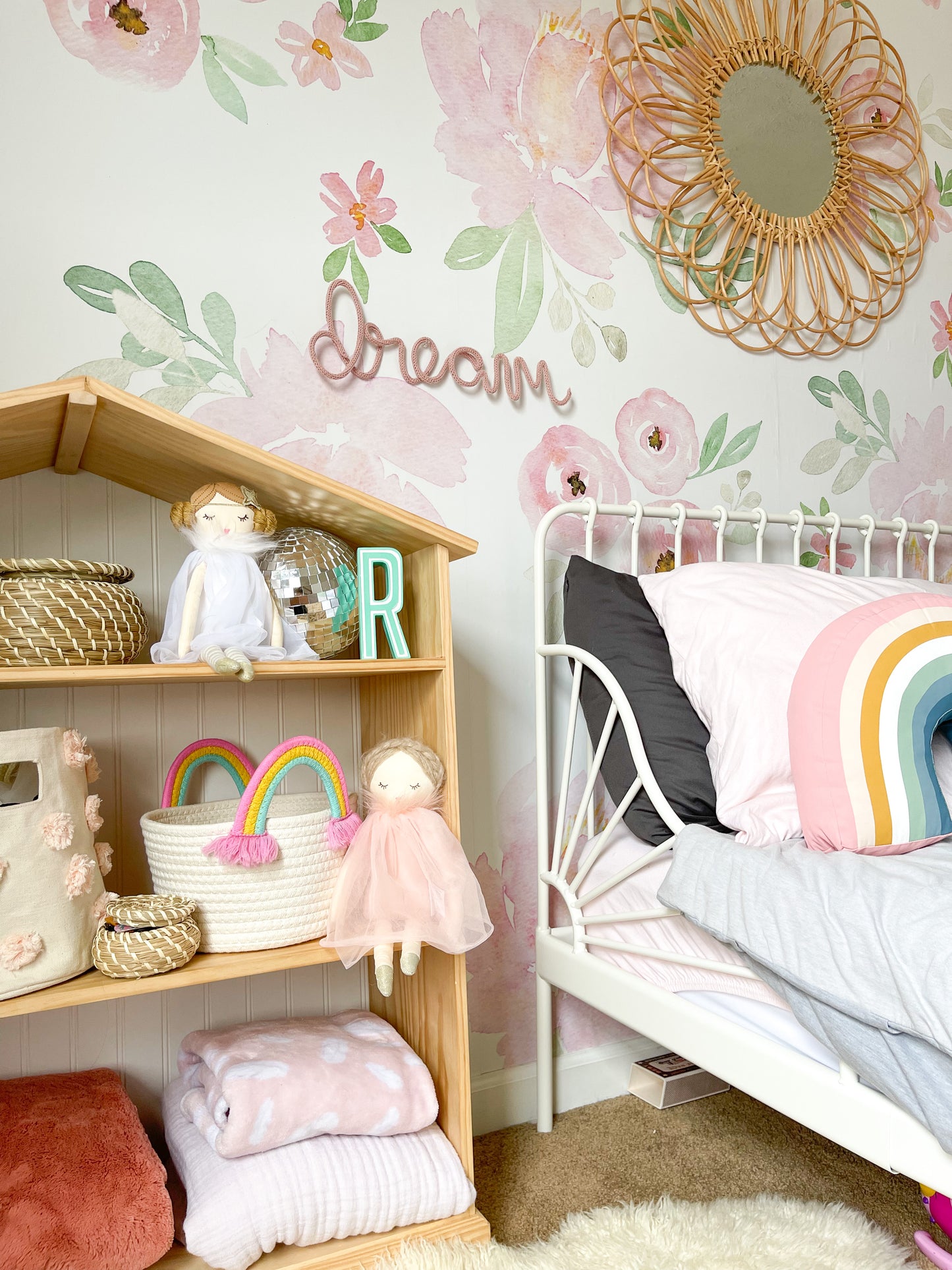 knitted wire word "dream" hung on the wall of a toddlerr girl's room.